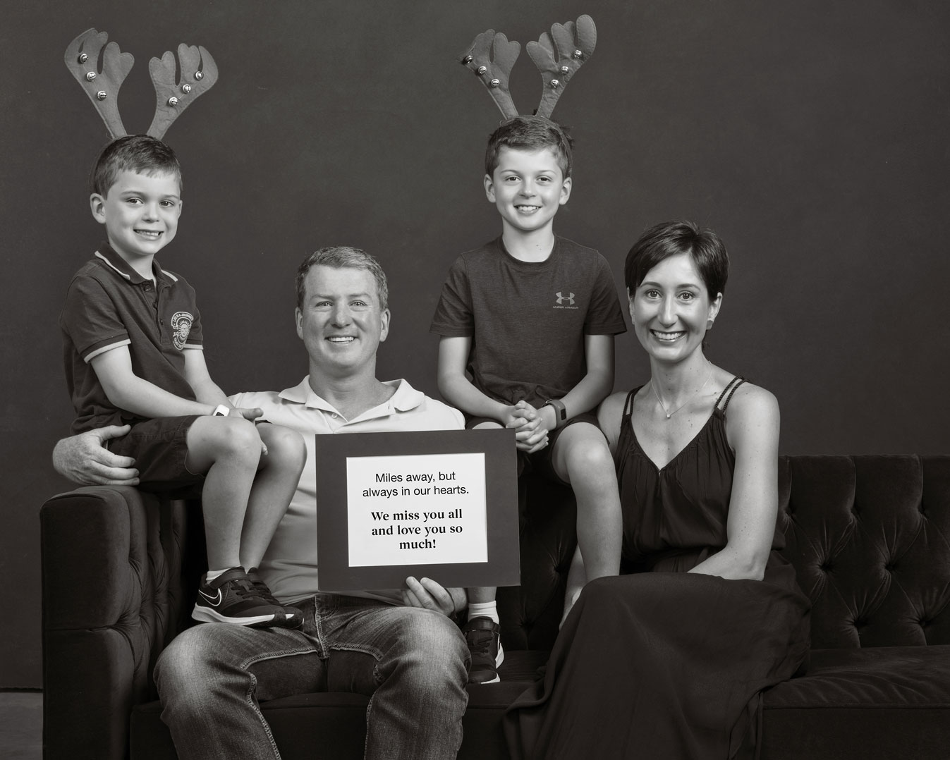 Family of four with a Christmas message for loved ones.