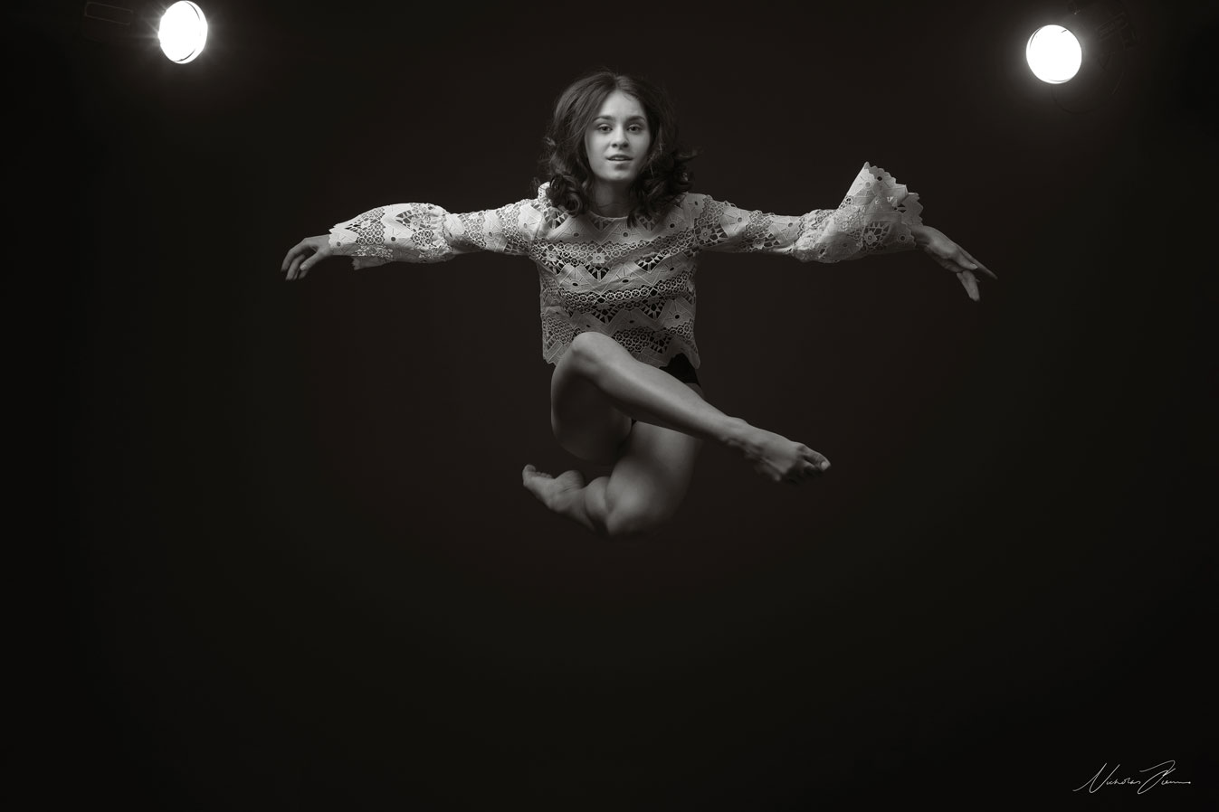 Black and white portrait of classical ballet and contemporary dance teacher Pheobe Walker, captured mid-air