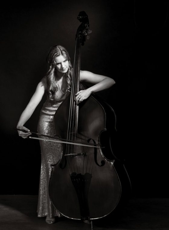 Black and white portrait of Sydney artist Bontia Williams playing her double bass.